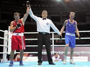 4 October 2011; Referee Martin Tadic, Croatia, raises the hand of Egidijus Kavaliauskas, Lithuania, following his 69kg bout victory over Roy Sheehan, St Michael's Athy B.C., Kildare, representing Ireland. Roy Sheehan was defeated on a score of 11-7. 2011 AIBA World Boxing Championships - Last 16, Roy Sheehan v Egidijus Kavaliauskas. Heydar Aliyev Sports and Exhibition Complex, Baku, Azerbaijan. Picture credit: Stephen McCarthy / SPORTSFILE