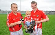 9 October 2011; Edenderry players Wayne Mooney, left, and Sean Pender, celebrate after victory over Clara with Eoin Plunkett, aged 18 months, from Edenderry, sitting in the cup. Tullamore Court Hotel Senior Football Final, Clara v Edenderry, O'Connor Park, Tullamore, Co. Offaly. Picture credit: Diarmuid Greene / SPORTSFILE