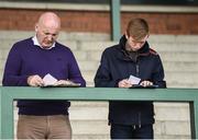 18 April 2017; Racegoers study the form prior to racing at the Fairyhouse Easter Festival at Fairyhouse Racecourse in Ratoath, Co Meath. Photo by Seb Daly/Sportsfile