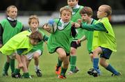 11 September 2011; Jack Roberts, centre, age 7, green bib, in action against Paul O'Dwyer, left, and Darragh McDonald, right, from Naas, Co. Kildare, during the Leinster Rugby Club Open Day. Naas RFC, Co. Kildare. Picture credit: Barry Cregg / SPORTSFILE
