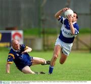 6 May 2002; Laois's Tom Kelly is tackled by Wicklow's Adrian Foley.  Wicklow v Laois, Leinster Senior Football Championship, Dr. Cullen Park, Carlow. Picture credit; Brendan Moran / SPORTSFILE
