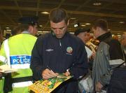 17 May 2002; Republic of Ireland cpatain Roy Keane signs autographs for fans at Dublin Airport prior to the team's departure to their base on Saipan island in preparation tor the World Cup 2002 in Japan and Korea. Soccer. Picture credit; David Maher / SPORTSFILE *EDI*