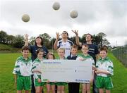 12 October 2011; Pictured at St Josephs GAA Club Ederney, in Fermanagh, were Dearbhaile McHugh, club tresurer St Josephs GAA Club Ederney, Sean Og O hAilpin, Ulster Bank GAA Force Ambassador, and Sean Donnelly, Club Sectretary St Josephs GAA Club Ederney, with Eoghan Donnelly, Eirin McMenamin, Katie Teague, Shauna McElhill, Sean Cassidy, Darragh McGee and John McElhill, club players and pupils of St Joseph's PS Ederney. St Josephs GAA Club Ederney, in Fermanagh, received a major boost as Ulster Bank announced them as winners of ‘Ulster Bank GAA Force’ – a major club focused initiative supporting local GAA clubs by giving them the opportunity to refurbish and upgrade their facilities. Ulster Bank GAA Force was introduced this summer to coincide with Ulster Bank’s sponsorship of the GAA Football All-Ireland Championships. St Josephs GAA Club was awarded a support package worth €22,000. Four runners up were also awarded support packages worth €5,000. St. Joseph's GAA Club, Drumkeen, Ederney, Co. Fermanagh. Picture credit: Oliver McVeigh / SPORTSFILE