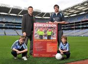 19 October 2011; The GAA has teamed up with brain injury specialists Acquired Brain Injury Ireland to back their Mind Your Head campaign; educating players about the signs and symptoms of Concussion, through an Educational Concussion Poster Campaign. This poster campaign will be distributed to over 1800 GAA clubs throughout the country, reaching out to all players of every age and level. Present at the launch were GPA CEO Dessie Farrell, with Dublin footballer and ABI Ireland ambassador Michael Darragh Macauley, with Sean O'Connell, left, age 9, from Stepaside, Co. Dublin, and Mark Bailey, age 8, from Killiney, Co. Dublin. GAA and ABI Ireland Launch Concussion Awareness Campaign, Croke Park, Dublin. Picture credit: David Maher / SPORTSFILE