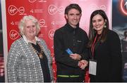 23 April 2017; Shane O'Neill is presented with his award from Annette Nidhathlaoi, right, Marketing, Virgin Media, and Georgina Drumm, left, President of Athletics Ireland, after placing third in the Virgin Media Night Run at Spencer Dock Hotel, in Dublin. Photo by Cody Glenn/Sportsfile