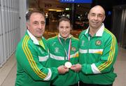 23 October 2011; Katie Taylor, Ireland, and coaches Zaur Antia, left, and father Pete on arrival into Dublin Airport following her 10-5 victory over Sofya Ochigava, Russia, in the 60kg Final at the 8th European Women's Boxing Championships, in Topsportcentrum, Rotterdam, Netherlands. Dublin Airport, Dublin. Picture credit; Stephen McCarthy / SPORTSFILE