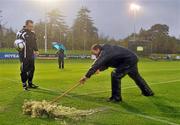 24 October 2011; Referee Neil Doyle watches as UCD sectretary Dick Shakespeare brushes water off the pitch before the Airtricity League Premier Division game between UCD and Shamrock Rovers was postponed due to a waterlogged pitch. Airtricity League Premier Division, UCD v Shamrock Rovers, The UCD Bowl, Belfield, Dublin. Picture credit: David Maher / SPORTSFILE
