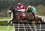 26 April 2017; Champagne Classic, left, with Bryan Cooper up, jump the last on their way to winning the Irish Daily Mirror Novice Hurdle at Punchestown Racecourse in Naas, Co. Kildare. Photo by Seb Daly/Sportsfile