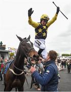 28 April 2017; Jockey Patrick Mullins dismounts Bacardys after winning the Tattersalls Ireland Champion Novice Hurdle at Punchestown Racecourse in Naas, Co. Kildare. Photo by Seb Daly/Sportsfile