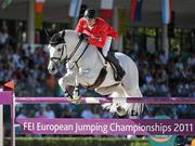 15 September 2011; Marco Kutscher, and Cornet Obolensky while competing in second days event at the FEI European Jumping Championships, Club de Campo Villa, Madrid, Spain. Picture credit: Ray McManus / SPORTSFILE