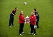 31 October 2011; Shelbourne's Ian Ryan, left, and Phillip Hughes, right, hold the FAI Ford Cup as team-mates John Sullivan, left, and Sean Byrne, right, practice their heading techniques ahead of their side's FAI Ford Cup Final against Sligo Rovers on Sunday November 6th. FAI Ford Cup Final Media Day 2011, Tolka Park, Dublin. Picture credit: Barry Cregg / SPORTSFILE