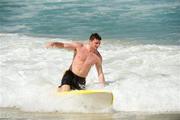 2 November 2011; Ireland's Pearce Hanley tries his hand at surfing during a visit to Surfers Paradise Beach as the players relax in advance of the 2nd International Rules Series 2011 Test.  Surfers Paradise, Gold Coast, Australia. Picture credit: Ray McManus / SPORTSFILE