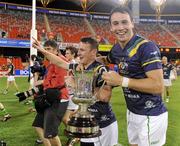 4 November 2011; Leighton Glynn and Finian Hanley, Ireland, celebrate with the Cormac McAnallen Perpetual Trophy after the game. International Rules 2nd Test, Australia v Ireland, Metricon Stadium, Gold Coast, Australia. Picture credit: Ray McManus / SPORTSFILE