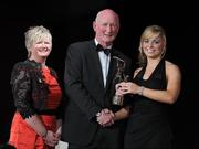 5 November 2011; Cork's Anna Geary is presented with her 2011 Camogie All-Star award by Joan O' Flynn, President of the Camogie Association, and Brian Cody, Kilkenny hurling manager, at the 2011 Camogie All-Stars in association with O’Neills. Citywest Hotel, Saggart, Co. Dublin. Picture credit: Stephen McCarthy / SPORTSFILE
