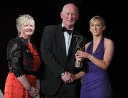 5 November 2011; Galway's Niamh Kilkenny is presented with her 2011 Camogie All-Star award by Joan O' Flynn, President of the Camogie Association, and Brian Cody, Kilkenny hurling manager, at the 2011 Camogie All-Stars in association with O’Neills. Citywest Hotel, Saggart, Co. Dublin. Picture credit: Stephen McCarthy / SPORTSFILE