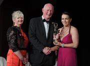 5 November 2011; Wexford's Ursula Jacob is presented with her 2011 Camogie All-Star award by Joan O' Flynn, President of the Camogie Association, and Brian Cody, Kilkenny hurling manager, at the 2011 Camogie All-Stars in association with O’Neills. Citywest Hotel, Saggart, Co. Dublin. Picture credit: Stephen McCarthy / SPORTSFILE