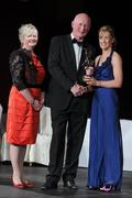 5 November 2011; Wexford's Kate Kelly is presented with her 2011 Camogie All-Star award by Brian Cody, Kilkenny hurling manager, and Joan O' Flynn, President of the Camogie Association, at the 2011 Camogie All-Stars in association with O’Neills. Citywest Hotel, Saggart, Co. Dublin. Picture credit: Stephen McCarthy / SPORTSFILE