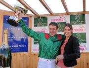 6 November 2011; Jockey Johnny Murtagh is presented with his 2011 Champion Flat Jockey Trophy by Guest of Honour Katie Taylor, World and European Boxing Champion. Leopardstown - 2011 Flat Season Finale Day, Leopardstown Racecourse, Dublin. Picture credit: Stephen McCarthy / SPORTSFILE