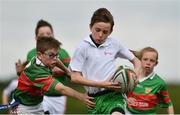 6 May 2017;  Shea Swift of Monaghan Town, Co Monaghan, is tagged by Jack O'Neill of Quin-Clooney, Co Clare, whilst competing in the U14 and O11 mixed tag rugby during the Aldi Community Games May Festival 2017 at National Sports Campus, in Abbotstown, Dublin. Photo by Sam Barnes/Sportsfile