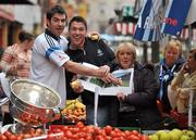 8 November 2011; Éamon Fennell and Michael Darragh McAuley, left, on Dublin’s Moore Street today with street trader Rosie Farrell to promote the official Dublin photography book, A Rare Auld Season. The book, which is supported by official team sponsor Vodafone, charts the success of the Dublin senior football team as they went in search of Sam. A Rare Auld Season has an RRP of €19.95, is produced by Irish sports photography agency Sportsfile and is on sale at www.sportsfile.com and from selected bookshops nationwide. Proceeds from the sale of A Rare Auld Season go towards the Dublin senior football team training and holiday fund. Moore Street, Dublin. Picture credit: Brian Lawless / SPORTSFILE