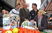 8 November 2011; Pat Gilroy, Éamon Fennell and Michael Darragh McAuley, left, on Dublin’s Moore Street today with street trader Rosie Farrell to promote the official Dublin photography book, A Rare Auld Season. The book, which is supported by official team sponsor Vodafone, charts the success of the Dublin senior football team as they went in search of Sam. A Rare Auld Season has an RRP of €19.95, is produced by Irish sports photography agency Sportsfile and is on sale at www.sportsfile.com and from selected bookshops nationwide. Proceeds from the sale of A Rare Auld Season go towards the Dublin senior football team training and holiday fund. Moore Street, Dublin. Picture credit: Brian Lawless / SPORTSFILE