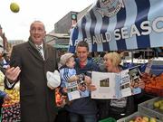 8 November 2011; Pat Gilroy on Dublin’s Moore Street today with street trader Rosie Farrell, her grandson Lennon Owens, age 1, and his dad Ross Owens, to promote the official Dublin photography book, A Rare Auld Season. The book, which is supported by official team sponsor Vodafone, charts the success of the Dublin senior football team as they went in search of Sam. A Rare Auld Season has an RRP of €19.95, is produced by Irish sports photography agency Sportsfile and is on sale at www.sportsfile.com and from selected bookshops nationwide. Proceeds from the sale of A Rare Auld Season go towards the Dublin senior football team training and holiday fund. Moore Street, Dublin. Picture credit: Brian Lawless / SPORTSFILE