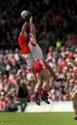 19 May 2002; Colin Holmes of Tyrone in action against Armagh's John Toal during the Bank of Ireland Ulster Senior Football Championship Quarter-Final match between Armagh and Tyrone at St Tiernach's Park in Clones, Monaghan. Photo by Pat Murphy/Sportsfile