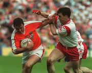 19 May 2002; Aidan O'Rourke of Armagh in action against Tyrone's Brian Robinson during the Bank of Ireland Ulster Senior Football Championship Quarter-Final match between Armagh and Tyrone at St Tiernach's Park in Clones, Monaghan. Photo by Pat Murphy/Sportsfile
