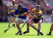 19 May 2002; Thomas Costello of Tipperary in action against James O'Connor of Clare during the Guinness Munster Senior Hurling Championship Quarter-Final match between Tipperary and Clare at Páirc U’ Chaoimh in Cork. Photo by Brendan Moran/Sportsfile