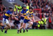 19 May 2002; Niall Gilligan of Clare in action against Paul Kelly, left, and David Kennedy of Tipperary during the Guinness Munster Senior Hurling Championship Quarter-Final match between Tipperary and Clare at Páirc U’ Chaoimh in Cork. Photo by Brendan Moran/Sportsfile