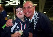 21 May 2002; Special Olympics Ireland had continued success on the international stage as an Irish team of eight athletes, sponsored by eircom, arrived back in Dublin Airport today from the 2002 European Table Tennis Tournament in Luxembourg. Pictured are athlete Ann Marie Talbot from Enniscorthy, Co. Wexford, who was welcomed home by her father Brendan. Photo by Ray McManus/Sportsfile