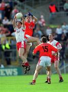 19 May 2002; Colin Holmes of Tyrone fields a high ball from Paul McGrane of Armagh during the Bank of Ireland Ulster Senior Football Championship Quarter-Final match between Armagh and Tyrone at St Tiernach's Park in Clones, Monaghan. Photo by Aoife Rice/Sportsfile