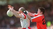19 May 2002; Chris Lawn of Tyrone in action against Ronan Clarke of Armagh during the Bank of Ireland Ulster Senior Football Championship Quarter-Final match between Armagh and Tyrone at St Tiernach's Park in Clones, Monaghan. Photo by Aoife Rice/Sportsfile