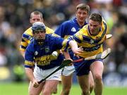 19 May 2002; Eugene O'Neill of Tipperary in action against John Reddan of Clare during the Guinness Munster Senior Hurling Championship Quarter-Final match between Tipperary and Clare at Páirc U’ Chaoimh in Cork. Photo by Brendan Moran/Sportsfile