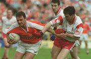 19 May 2002; Aidan O'Rourke of Armagh in action against Brian Robibson of Tyrone during the Bank of Ireland Ulster Senior Football Championship Quarter-Final match between Armagh and Tyrone at St Tiernach's Park in Clones, Monaghan. Photo by Pat Murphy/Sportsfile