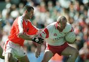 19 May 2002; Chris Lawn of Tyrone in action against Steven McDonnell of Armagh during the Bank of Ireland Ulster Senior Football Championship Quarter-Final match between Armagh and Tyrone at St Tiernach's Park in Clones, Monaghan. Photo by Aoife Rice/Sportsfile