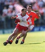 19 May 2002; Gerard Cavlan of Tyrone in action against Aidan O'Rourke of Armagh during the Bank of Ireland Ulster Senior Football Championship Quarter-Final match between Armagh and Tyrone at St Tiernach's Park in Clones, Monaghan. Photo by Aoife Rice/Sportsfile