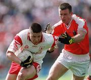 19 May 2002; Sean Cavanagh of Tyrone in action against Justin McNulty of Armagh during the Bank of Ireland Ulster Senior Football Championship Quarter-Final match between Armagh and Tyrone at St Tiernach's Park in Clones, Monaghan. Photo by Aoife Rice/Sportsfile