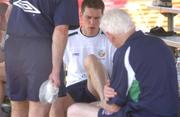 23 May 2002; Steve Finnan receives treatment to  his injured foot from team doctor Martin Walsh during a Republic of Ireland squad training session at Ada Gym in Susupe, Saipan, Northern Mariana Islands. Photo by David Maher/Sportsfile