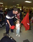 23 May 2002; Munster captain Mick Galwey with his daughter Neasa as they arrive at Cardiff Airport ahead of their Heineken Cup Final match against Leicester Tigers at the Millennium Stadium in Cardiff, Wales. Photo by Brendan Moran/Sportsfile