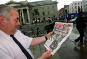 23 May 2002; Ned Daly, from Crumlin, Dublin, reads the Evening Herald newspaper, and the breaking story of Republic of Ireland captain Roy Keane's departure from the squad in Saipan, Northern Mariana Islands, ahead of the FIFA World Cup 2002 finals in South Korea and Japan. Photo by Damien Eagers/Sportsfile