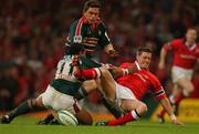 25 May 2002; Ronan O'Gara of Munster is tackled by Freddie Tuilagi, left, and Rod Kafer of Leicester during the Heineken Cup Final match between Leicester Tigers and Munster at the Millennium Stadium in Cardiff, Wales. Photo by Brendan Moran/Sportsfile