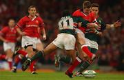 25 May 2002; Ronan O'Gara of Munster in action against Freddie Tuilagi, left, and Rod Kafer of Leicester during the Heineken Cup Final match between Leicester Tigers and Munster at the Millennium Stadium in Cardiff, Wales. Photo by Brendan Moran/Sportsfile