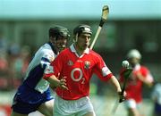 26 May 2002; Cork's Eamonn Collins races clear of Waterford's Tom Feeney during the Guinness Munster Senior Hurling Championship Semi-Final match between Waterford and Cork at Semple Stadium in Thurles, Tipperary. Photo by Brendan Moran/Sportsfile