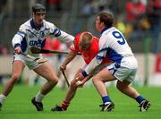 26 May 2002; Cork's Donal Broderick is tackled by Waterford's Victor O'Shea, left, Roy McGrath, right, during the Munster Intermediate Hurling Championship match between Waterford and Cork at Semple Stadium in Thurles, Tipperary. Photo by Brendan Moran/Sportsfile