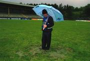 26 May 2002; GAA official Terence McShea inspects the pitch conditions prior to the abandonment of the Bank of Ireland Ulster Senior Football Championship Quarter-Final match between Donegal and Down at MacCumhail Park in Ballybofey, Donegal. Photo by Damien Eagers/Sportsfile