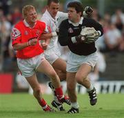26 May 2002; Enda Murphy of Kildare in action against JP Rooney of Louth during the Bank of Ireland Leinster Senior Football Championship Quarter-Final match between Kildare and Louth at Páirc Tailteann in Navan, Meath. Photo by Ray McManus/Sportsfile
