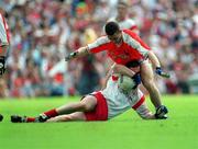 26 May 2002; Tyrone's Conor Gormley in action against Diarmuid Marsden of Armagh during the Bank of Ireland Ulster Senior Football Championship Quarter-Final Replay match between Armagh and Tyrone at St Tiernach's Park in Clones, Monaghan. Photo by Aoife Rice/Sportsfile