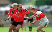 25 May 2002; Johnny McGrattan of Down in action against Gregory Bruton of Derry during the Guinness Ulster Senior Hurling Championship Semi-Final match between Down and Derry at Casement Park in Belfast. Photo by Damien Eagers/Sportsfile