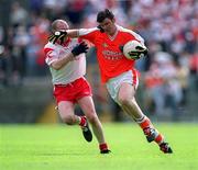 26 May 2002; Armagh's Ronan Clarke in action against Chris Lawn of Tyrone during the Bank of Ireland Ulster Senior Football Championship Quarter-Final Replay match between Armagh and Tyrone at St Tiernach's Park in Clones, Monaghan. Photo by Aoife Rice/Sportsfile